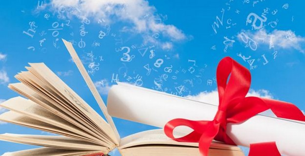 Blue sky with open book and paper rolled up wrapped with ribbon