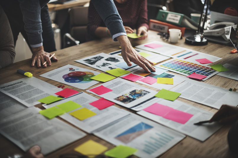 Project Leader working over desk of planning documents